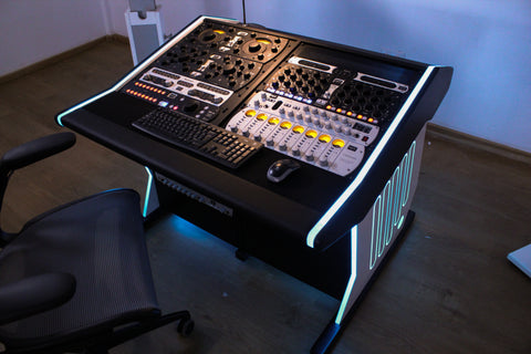 Music production console with illuminated edges in a room setting