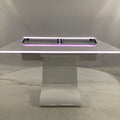 White studio table with LED strip lights on a white background